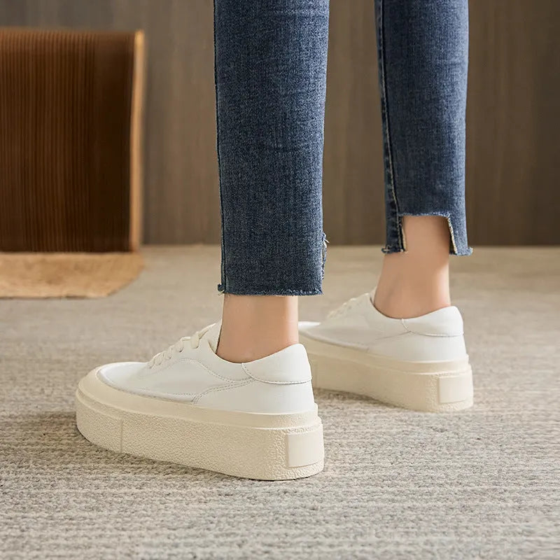 Women's black platform casual sports shoes with embossed leather upper and round toe.