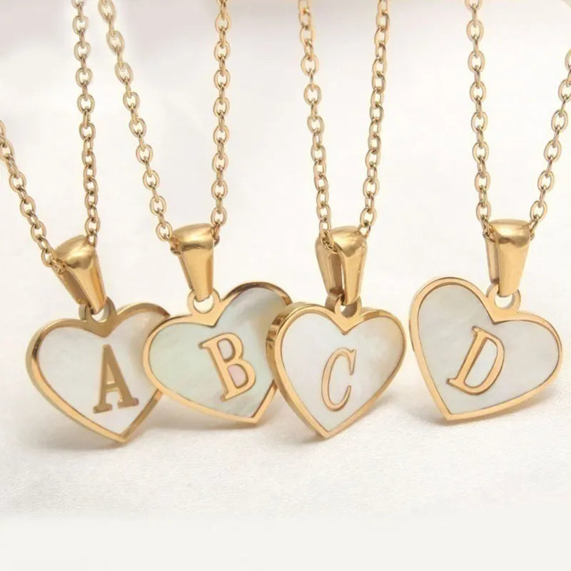 Gold heart necklace with white shell detail and personalised initial letter on adjustable chain