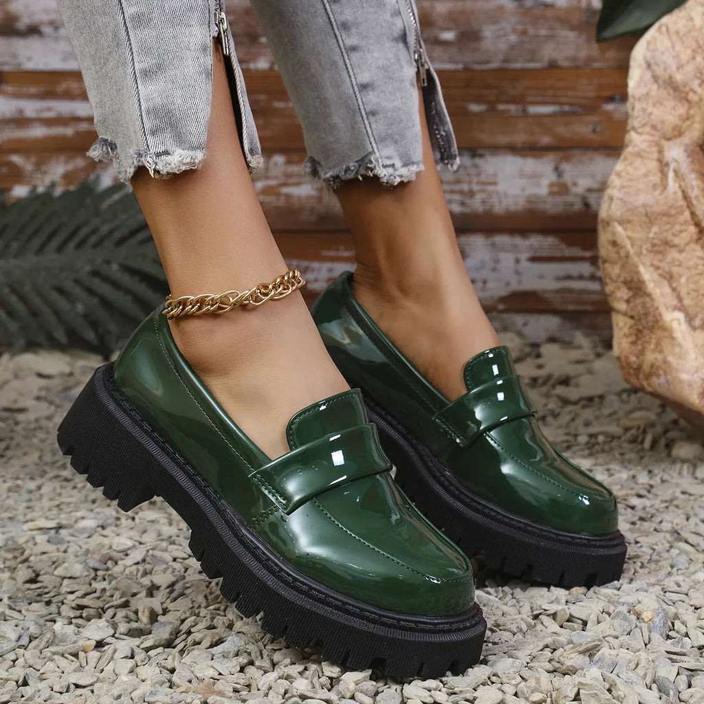 Plus size women's slip-on loafers in black with a chunky platform heel and rubber sole.