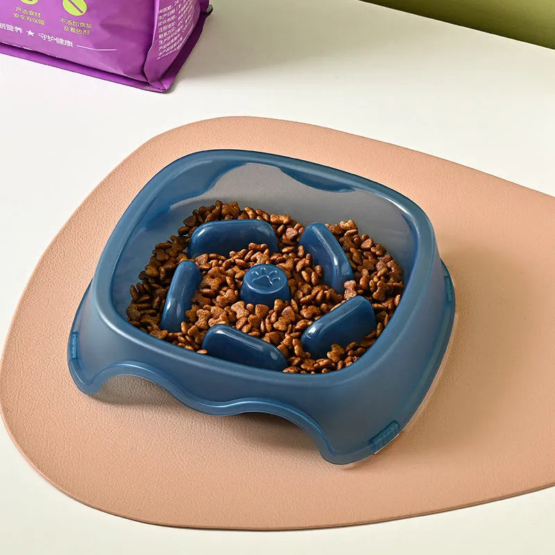 Blue plastic dog slow feeder bowl with anti-choking design on white background