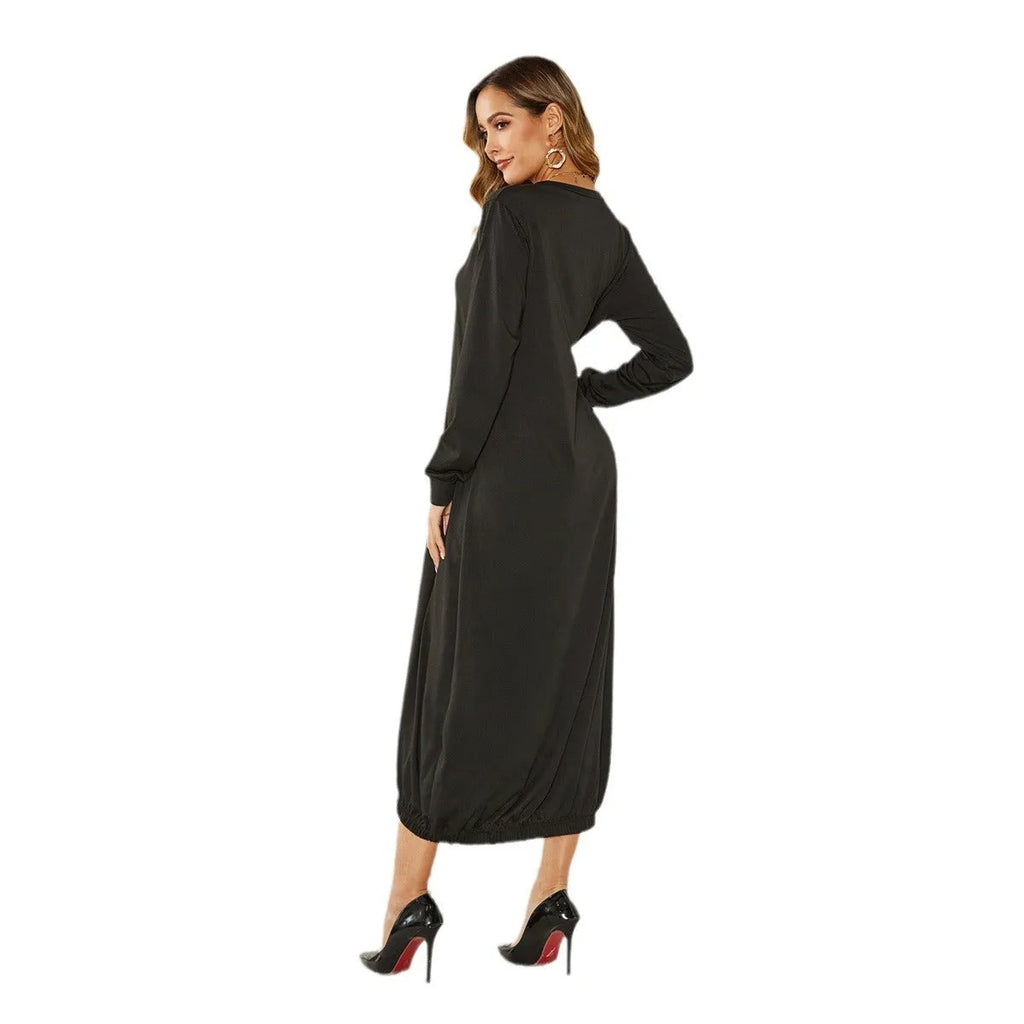 A grey loose-fitting long lantern dress with long sleeves and a crew neckline, laid flat.