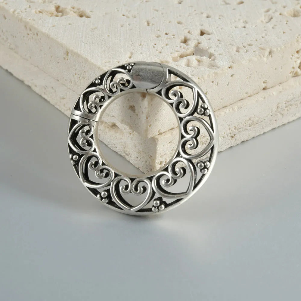 Retro heart-shaped hollow lotus magnetic earrings in stainless steel with antique finishes