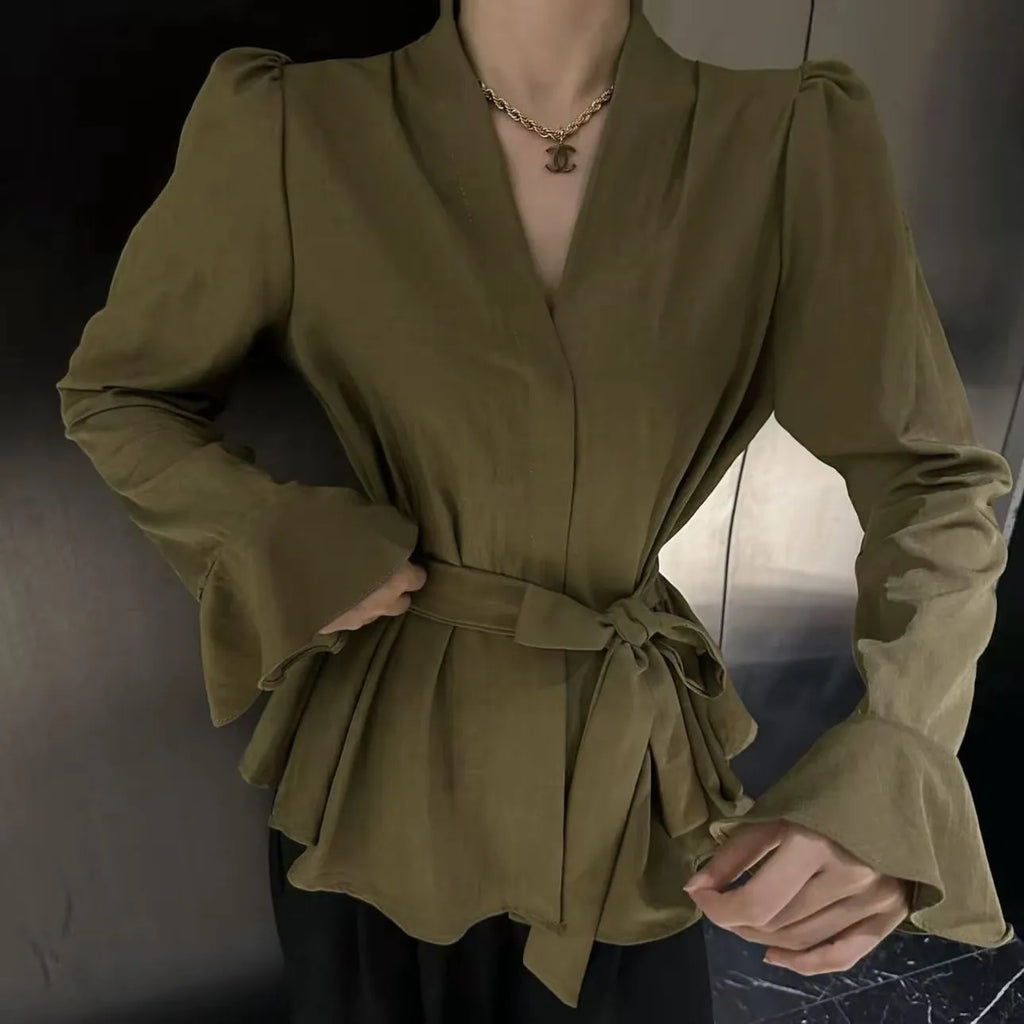 Women's black long sleeve shirt with irregular French collar, front tie, and bell sleeves