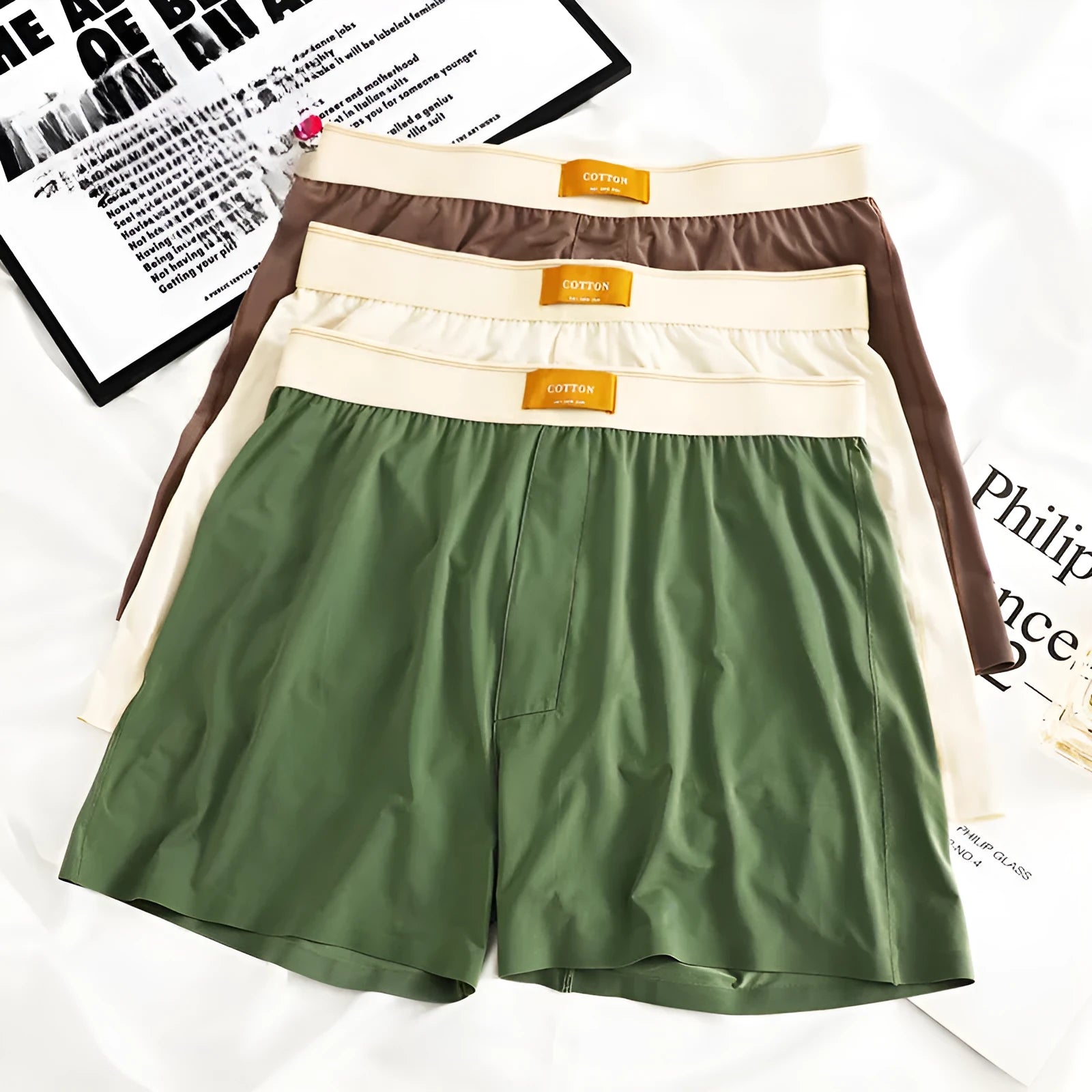 Men's loose fit ice silk underwear in solid colours showing mid-waist design and breathable fabric texture.