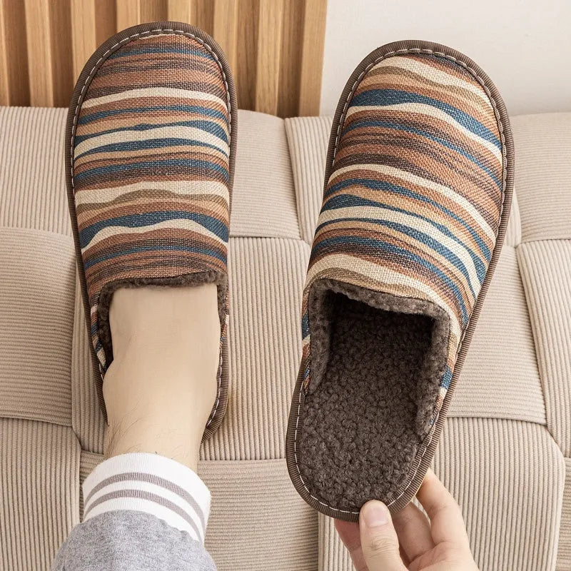 A pair of linen surface cotton lined slippers with a PVC sole, shown in a floral print colour option.
