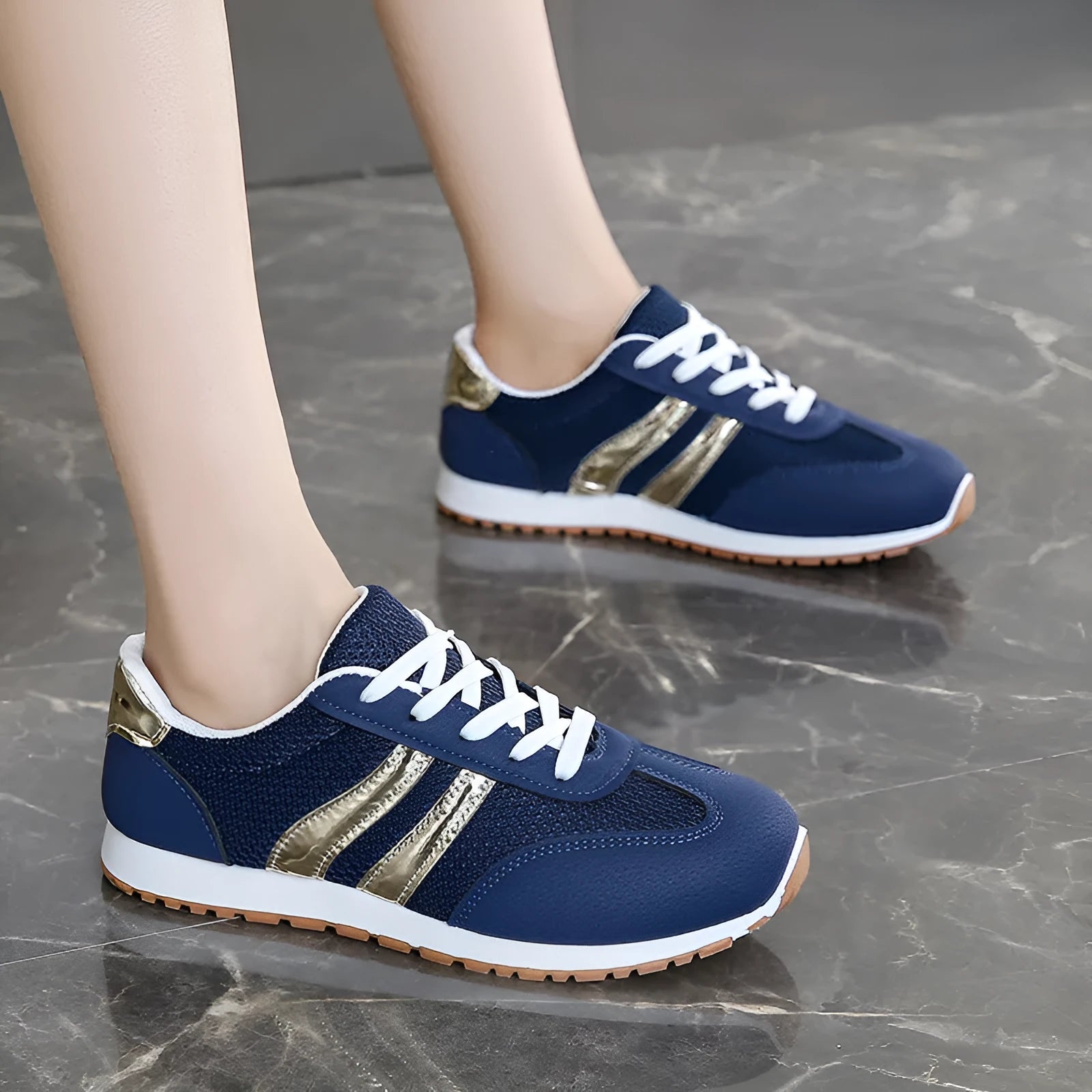 Blue women's artificial leather tennis shoes with cross shoulder straps and flat rubber sole.