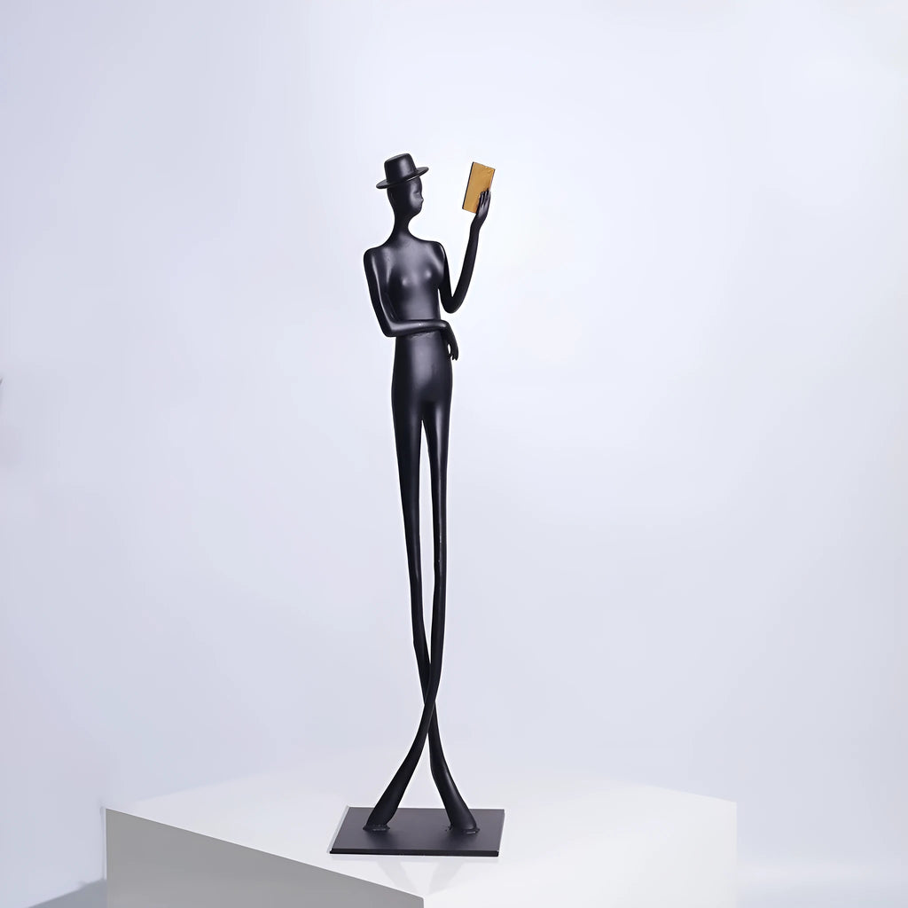 Tall black cast aluminium minimalist character sculpture on a desk, measuring 51cm in height.