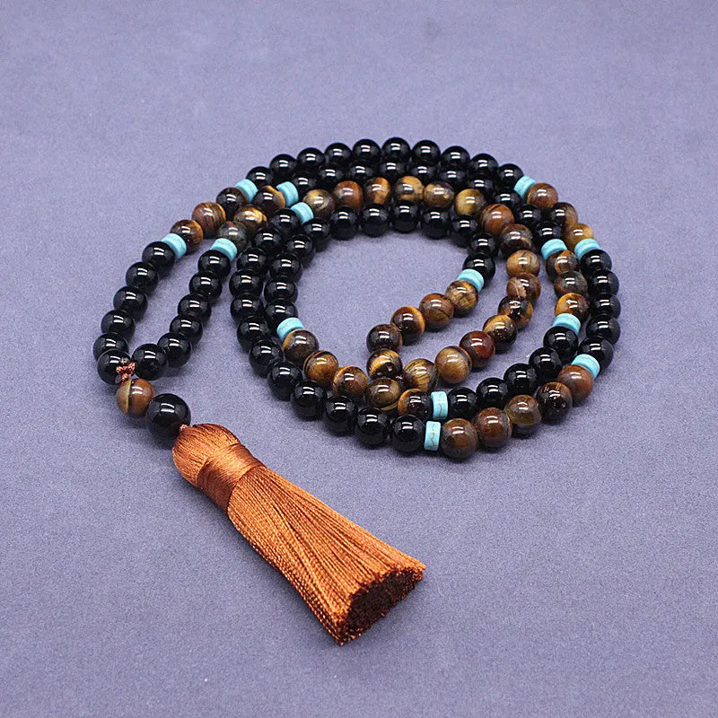 Black geometric agate bracelet and necklace set on a display background.