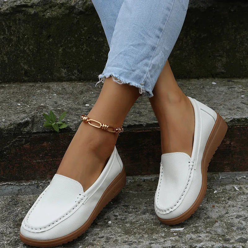 Women's flat loafer shoes in PU leather, showing round toe and car suture detail, on a rubber sole.