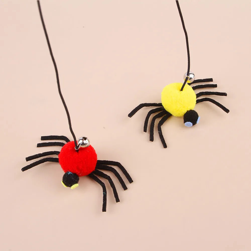 Red and yellow door-hanging cat toy with elastic rope, feather, bell and spider attachment for indoor feline play