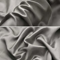 Dark grey envelope closure silk pillowcase on a bed.