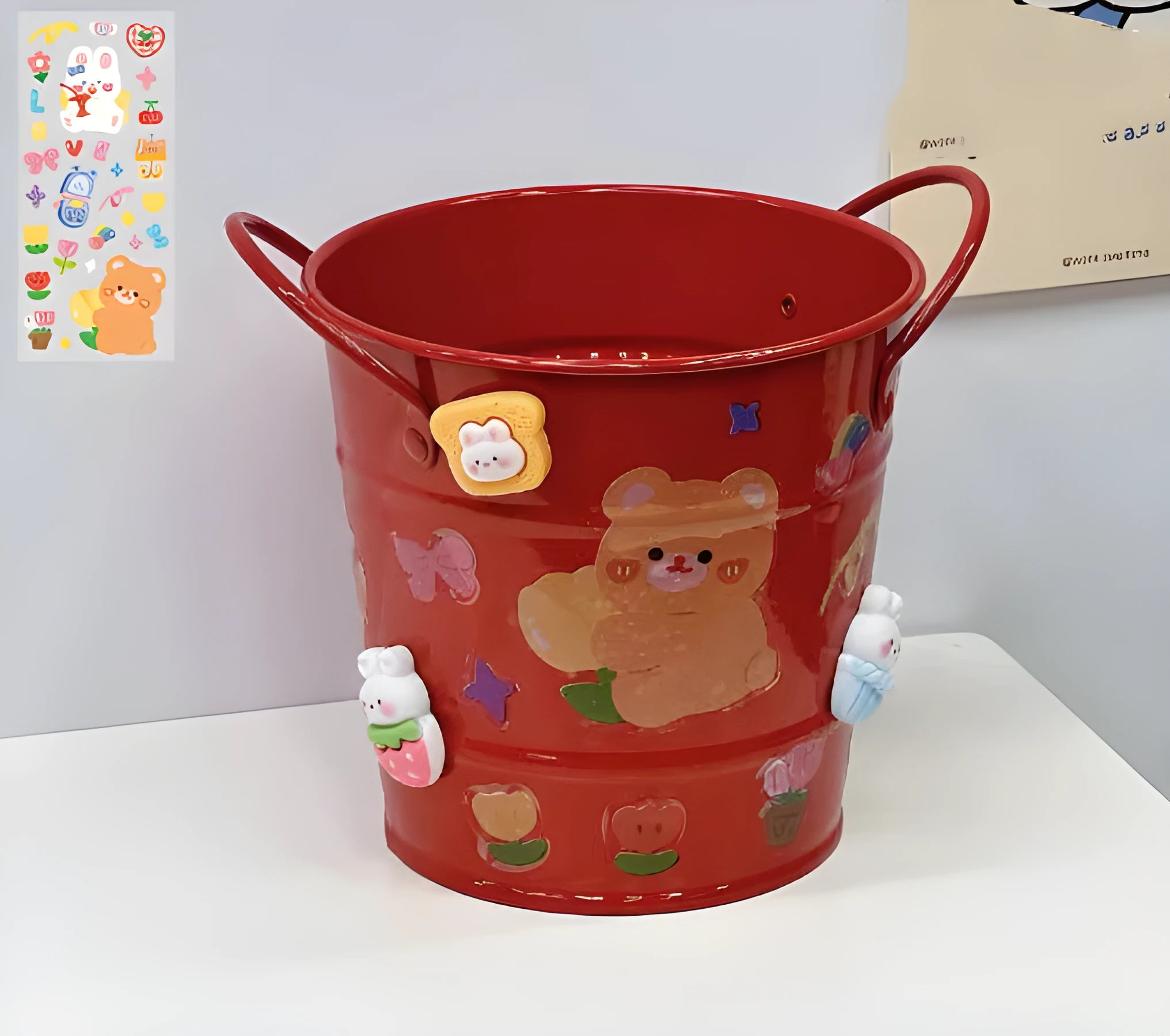 Round metal desktop pen holder in a choice of colours, some with decorative sticker patches.