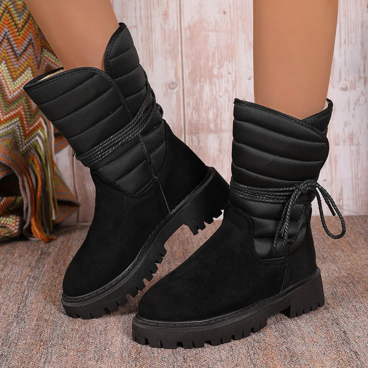 Women's black suede snow boots with chunky heel, lace-up design, and fleece lining