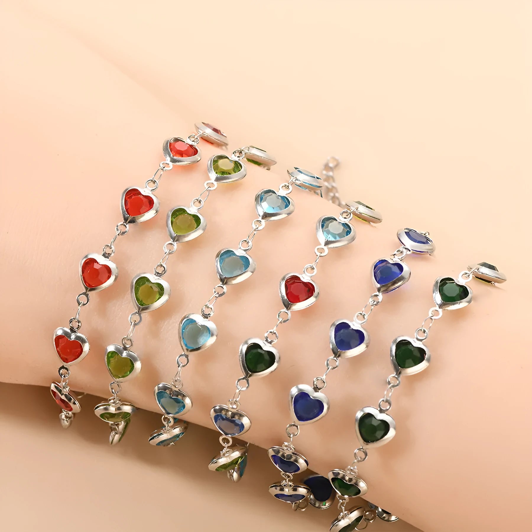 Devil's Eye geometric heart bracelet in stainless steel, shown in colourful, blue, green, and red finishes.
