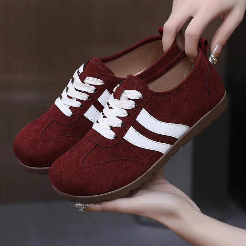 Women's vintage canvas sneakers in dark red and khaki with a round toe and flat rubber sole.
