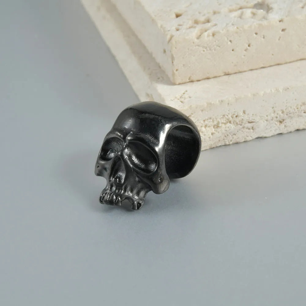 Geometric stainless steel earrings combining hollow skull and Buddha motifs with electroplated finish