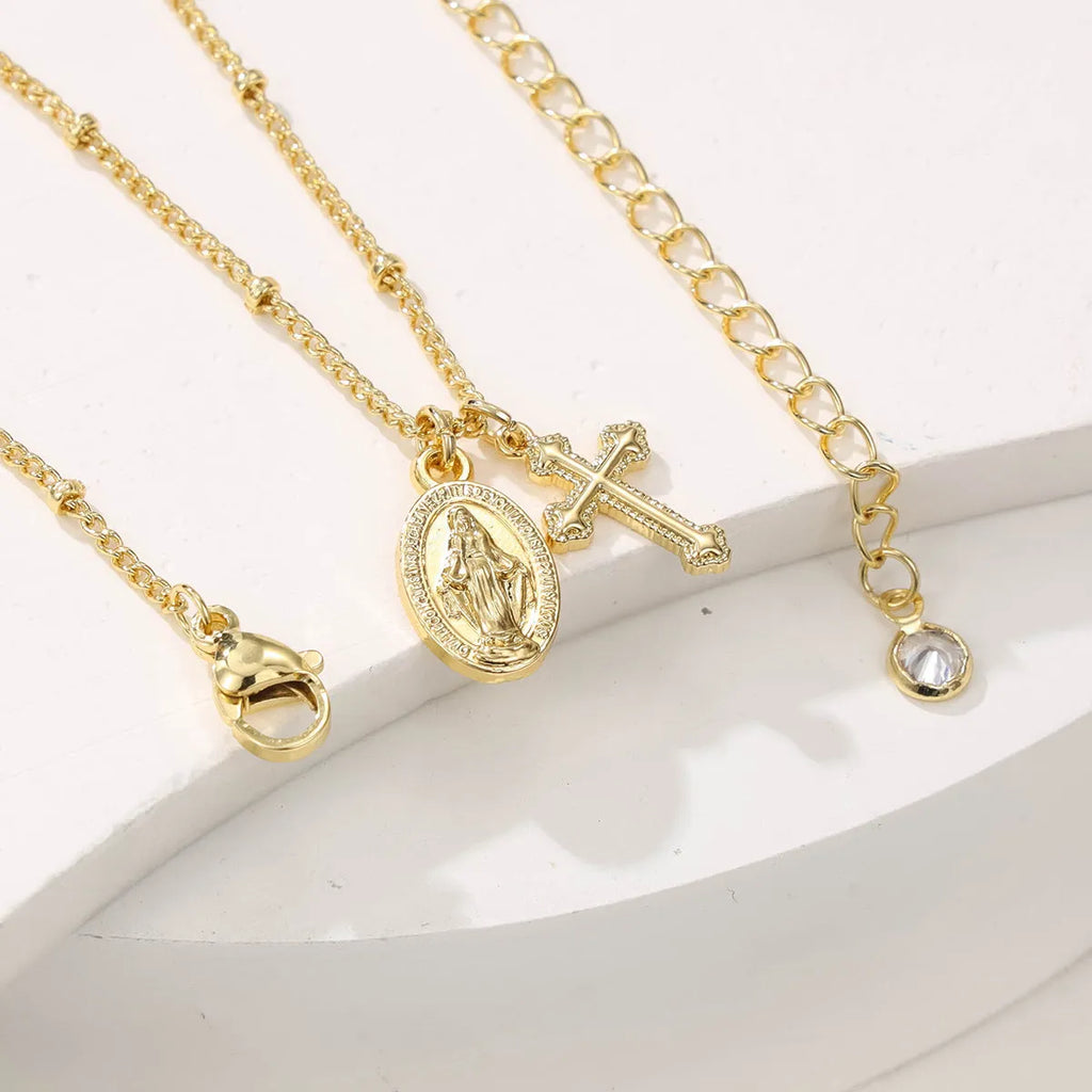 Gold Virgin Mary necklace with geometric cross pendant on copper chain