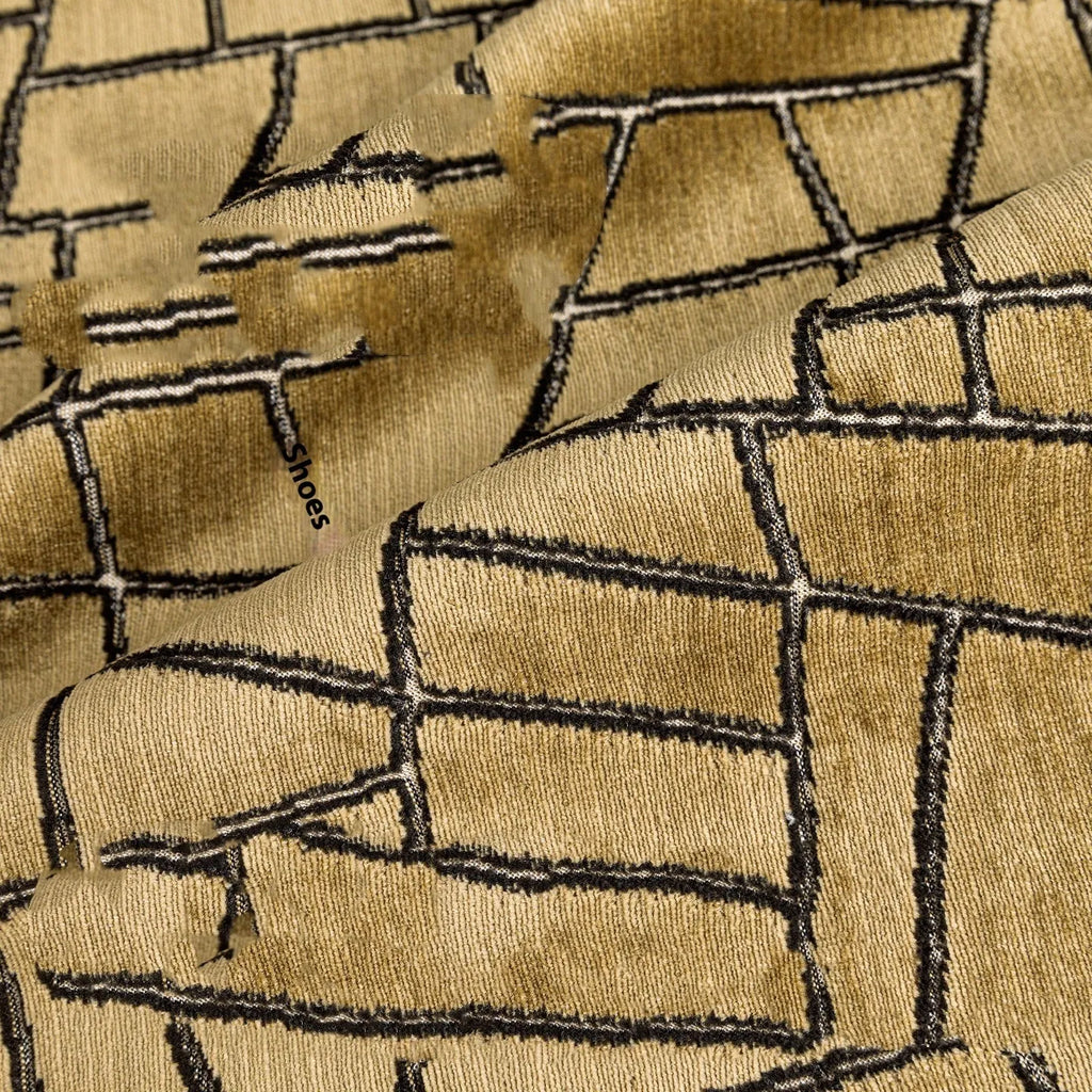 Tuhao gold geometric abstract pattern on a square decorative cushion with tassel detail.