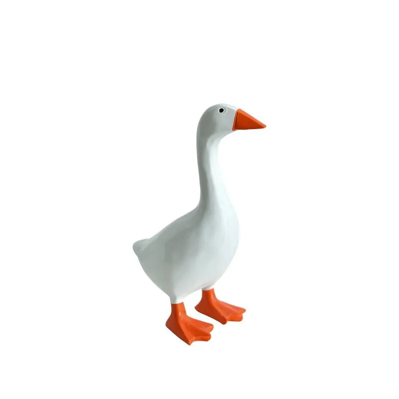 White simulation duck resin magnetic ornament on metal surface holding a note