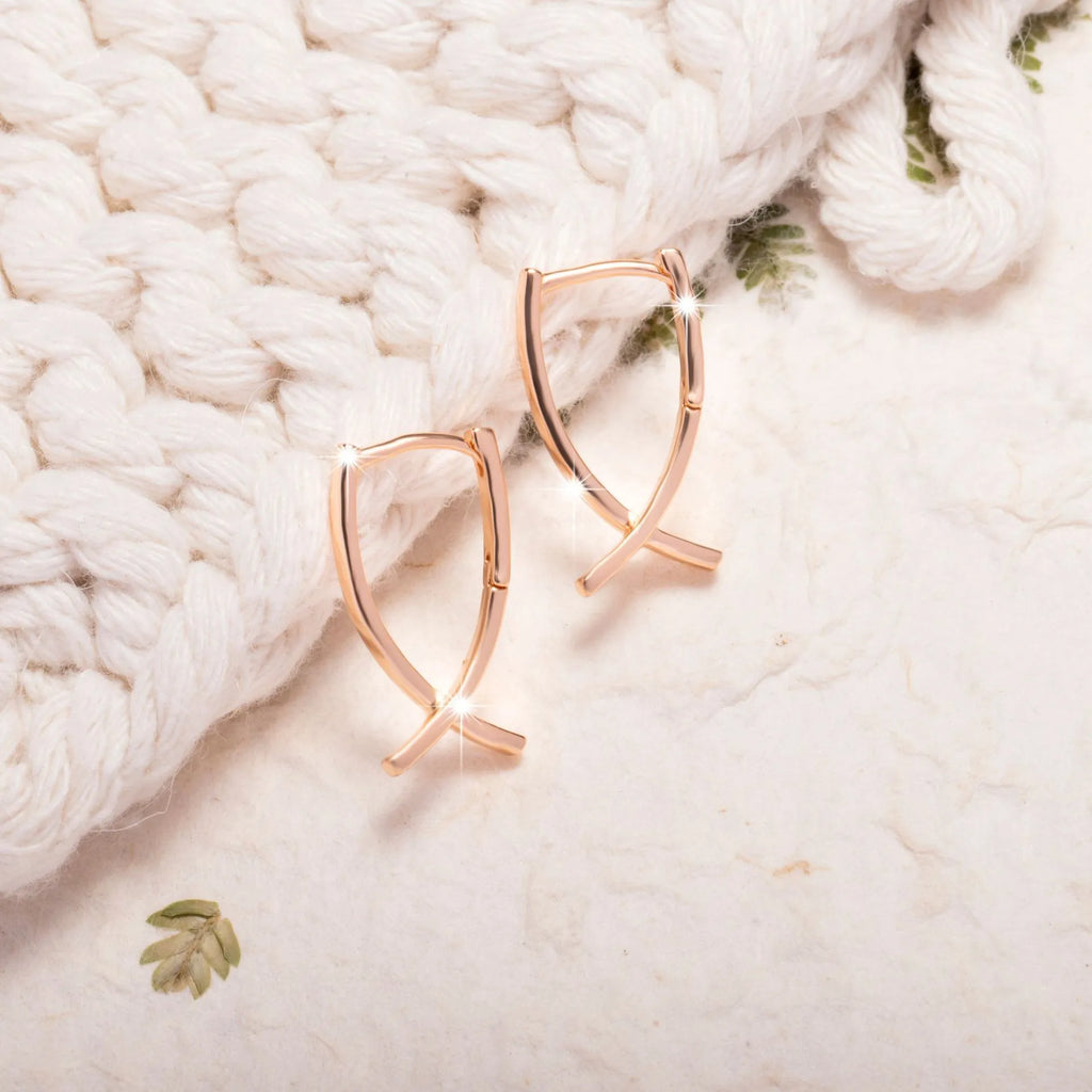 Rose gold cross shaped earrings with polished finish on copper material