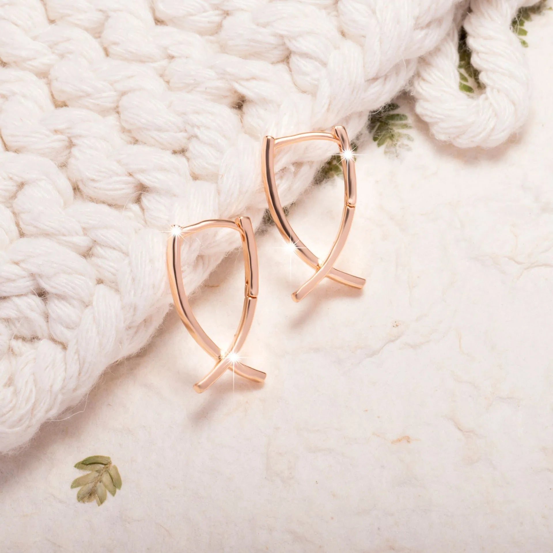 Rose gold cross shaped earrings with polished finish on copper material