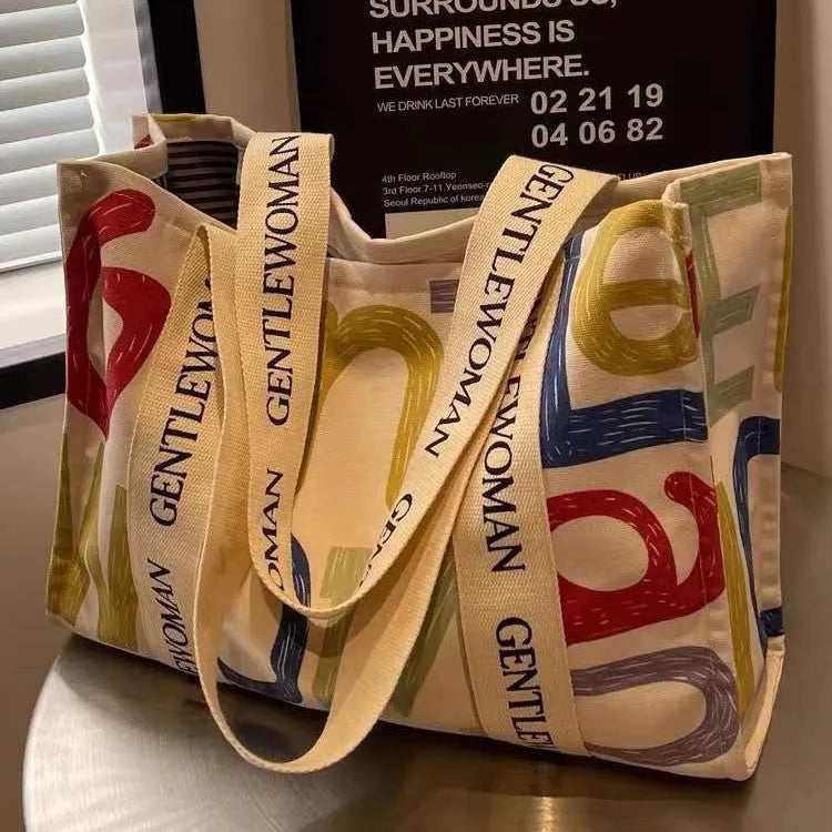 Large canvas women's tote bag with printed design, shown in available colour and pattern options