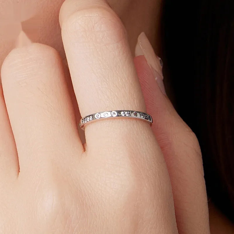 Silver I Love You password ring with oxidised black finish on a simple band, showing script engraving.