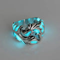 Close-up of an adjustable silver blue and green metal ring with a Chinese dragon pattern.
