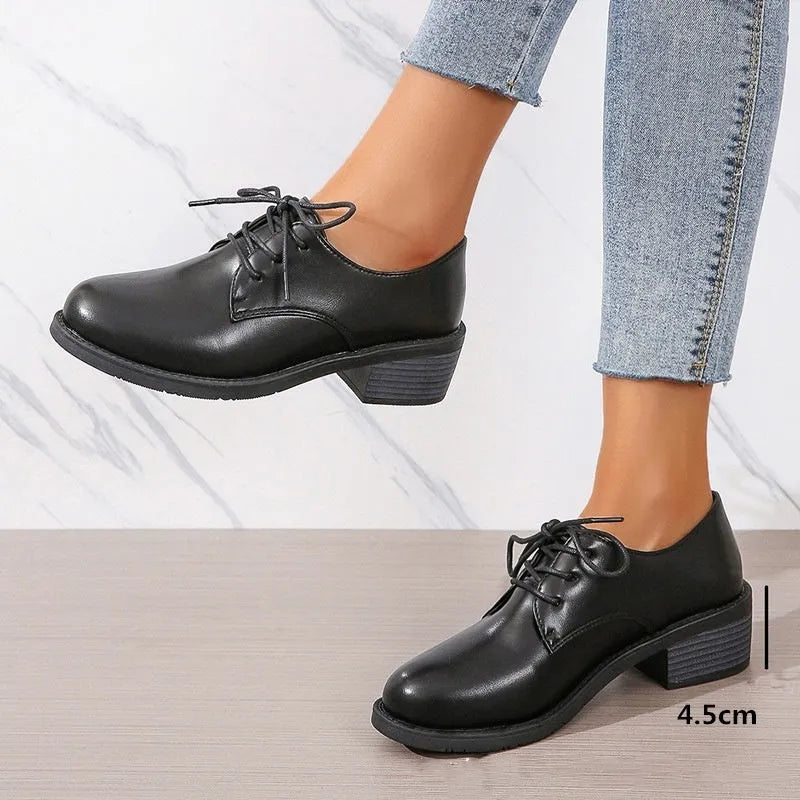 Black women's low-top shoes with a chunky thick heel and rubber sole.