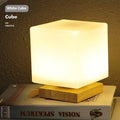 Nordic solid wood flower-shaped USB table lamp showing touch dimming and choice of cube or cylinder white light shapes.