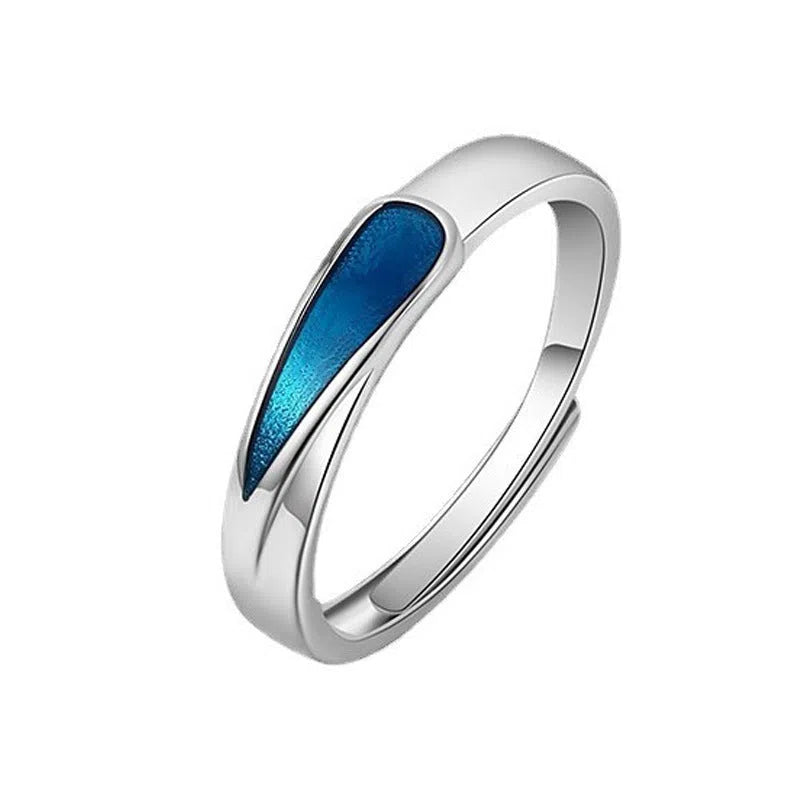 Blue tear drop copper ring with water drop shape and glue-drip finish on a dark background