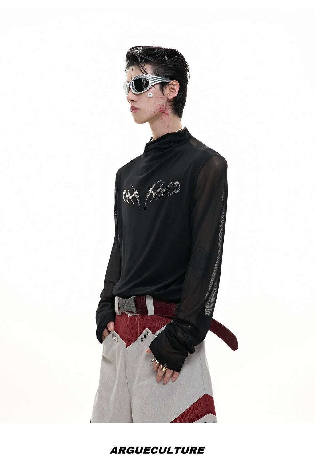 Man wearing a black slim fit long sleeve mesh base layer shirt.