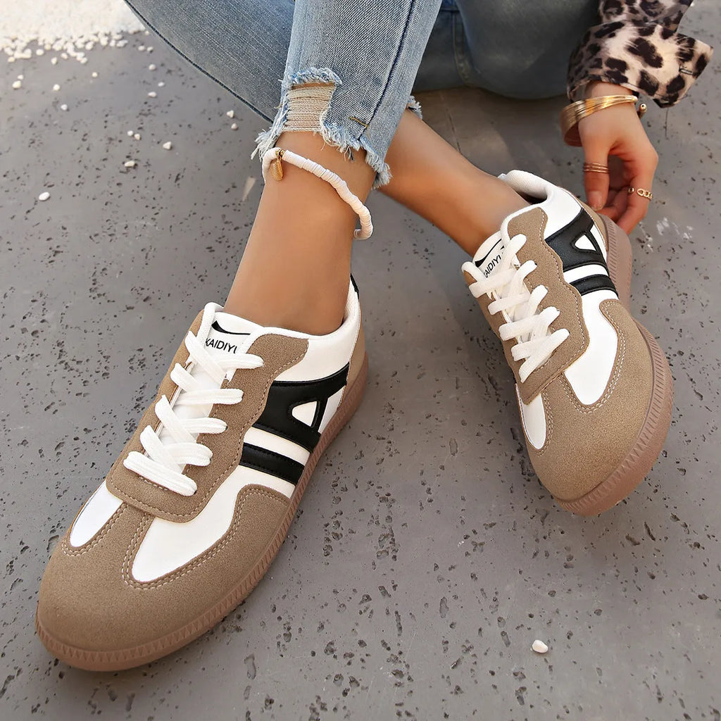 Women's retro grey jogging shoes with lace-up front and cross-strap detail on a rubber platform sole.