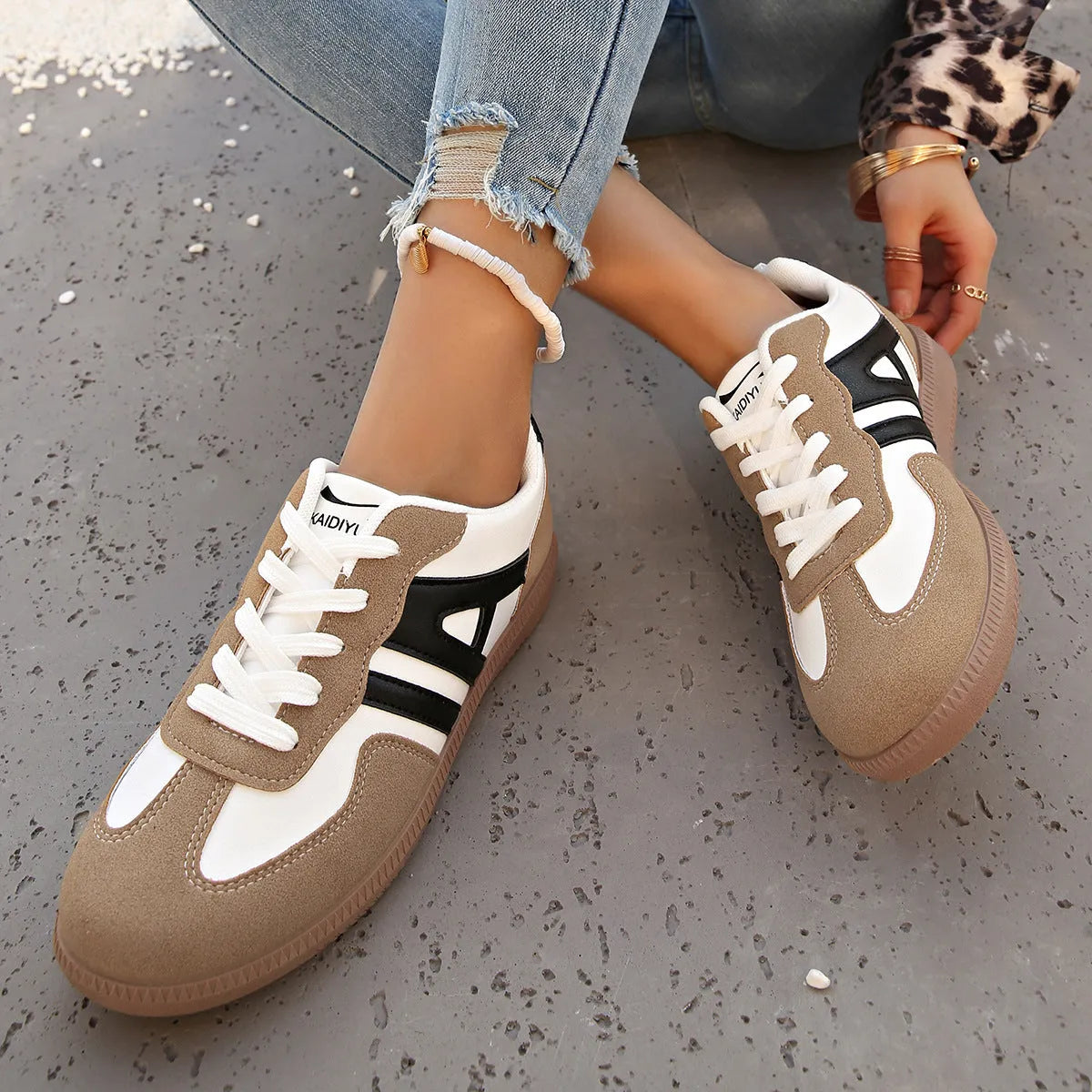 Women's retro grey jogging shoes with lace-up front and cross-strap detail on a rubber platform sole.