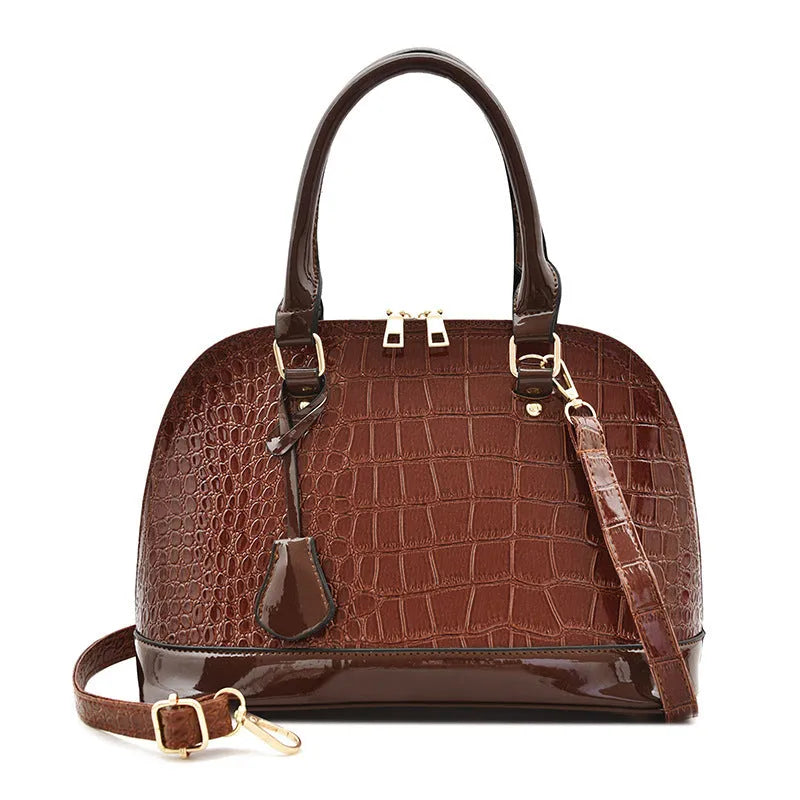Shiny black PU leather crossbody shoulder bag with a structured shell shape.