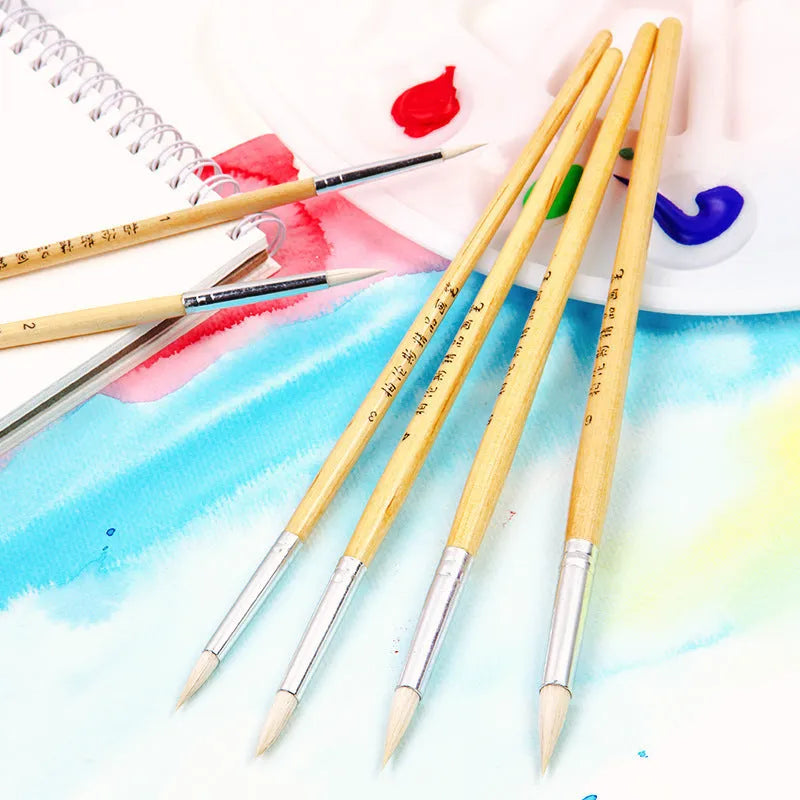 Six wooden pen brushes with pointed tips arranged together as an artistic brush set