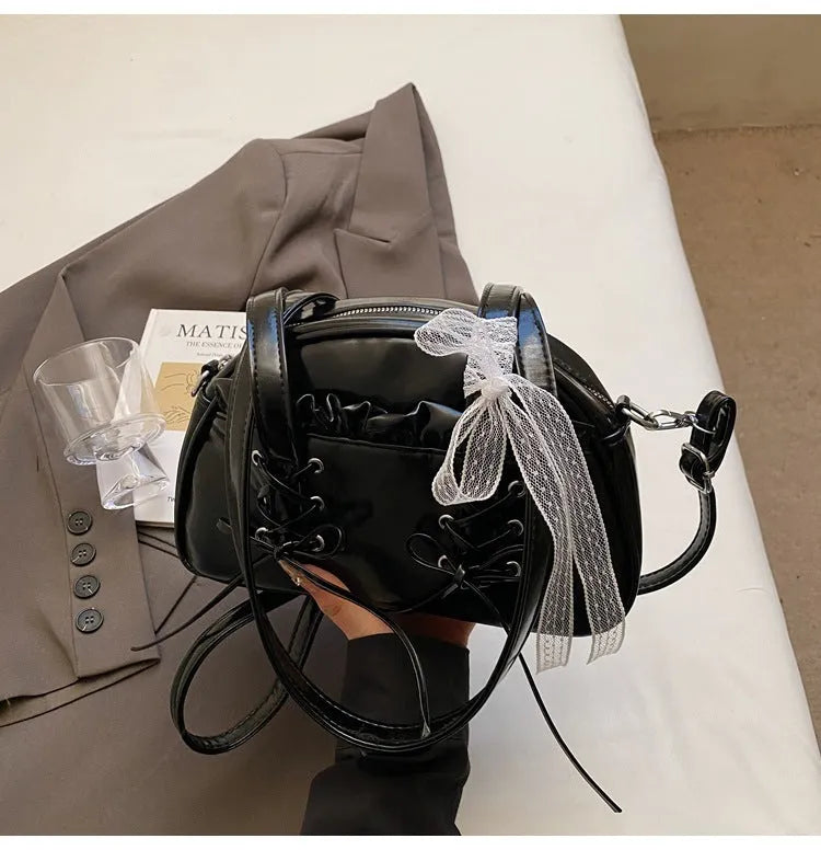 Milky white women's PU leather shoulder bag with a removable bandage bow and visible sewing thread detailing