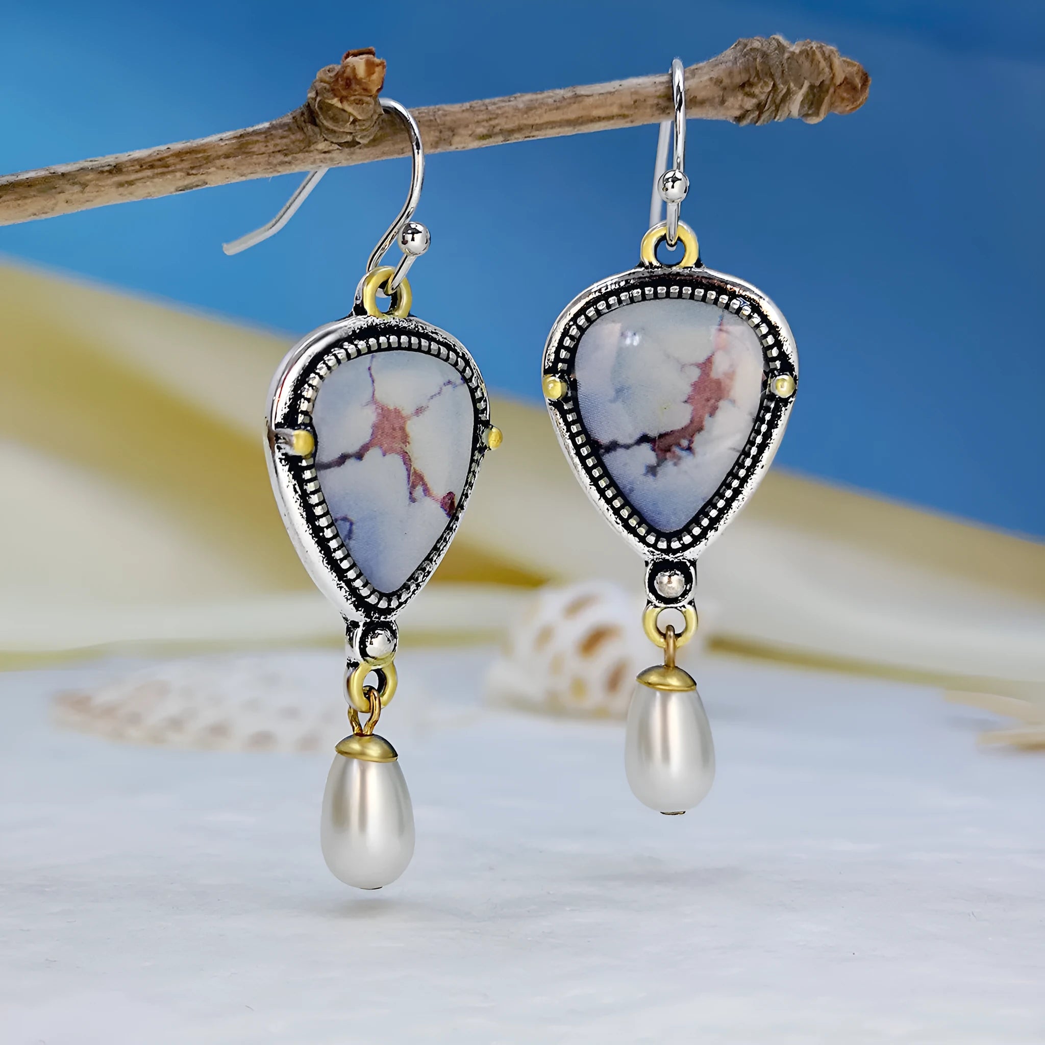 Retro blue geometric drop earrings with synthetic opal and white pearl details on electroplated metal.
