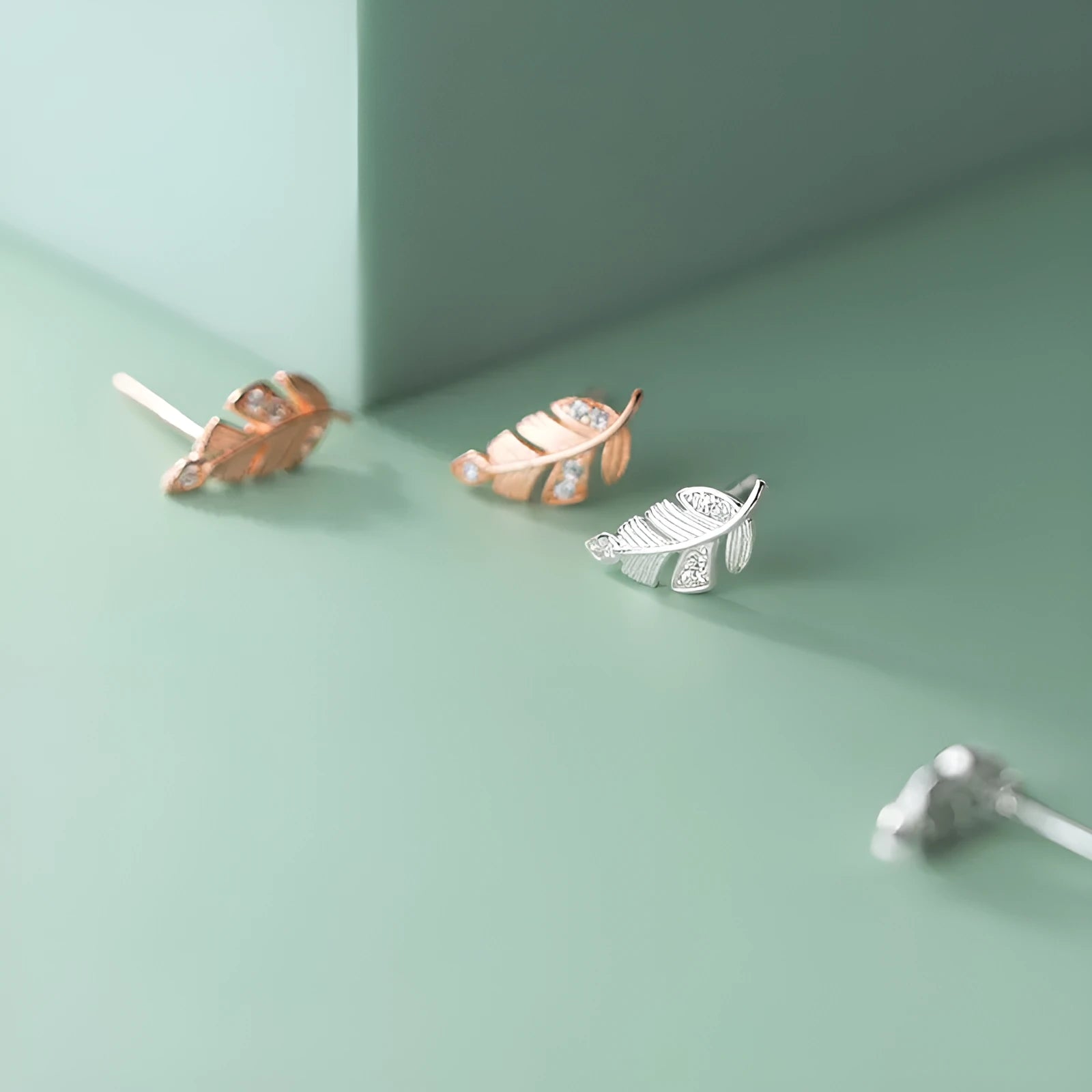 Copper willow leaf stud earrings with micro-inlaid leaf detail and geometric Mori style in rose gold and white gold colour