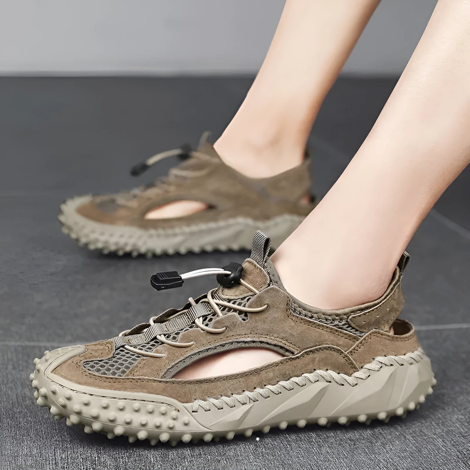 Men's black hollow sports sandals with leather mesh upper, rubber sole, and elastic band closure