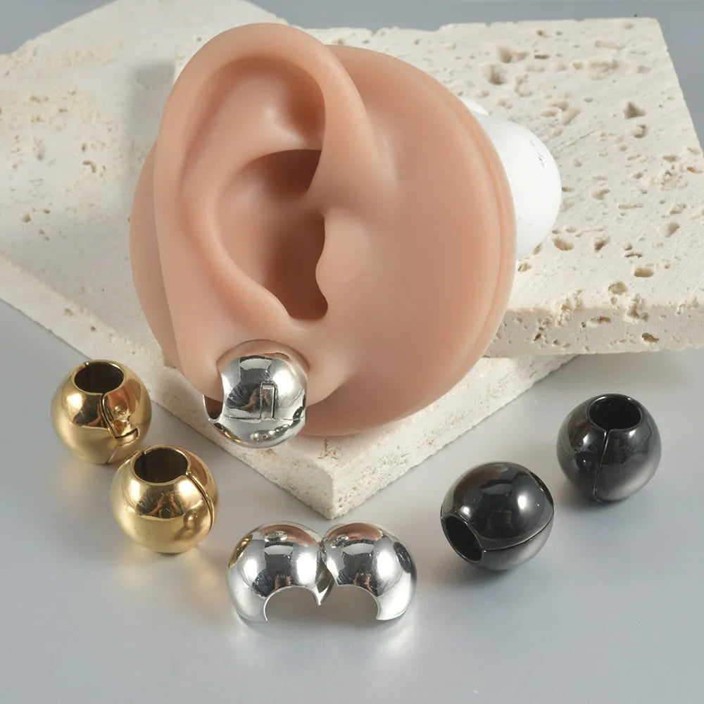 Geometric stainless steel earrings combining hollow skull and Buddha motifs with electroplated finish
