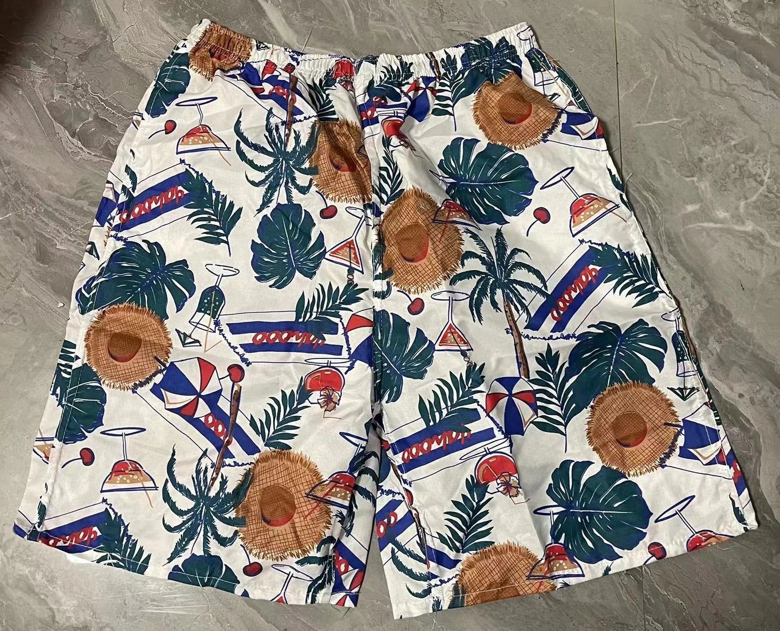Men's printed five-point swimming trunks with floral pattern in polyester fabric