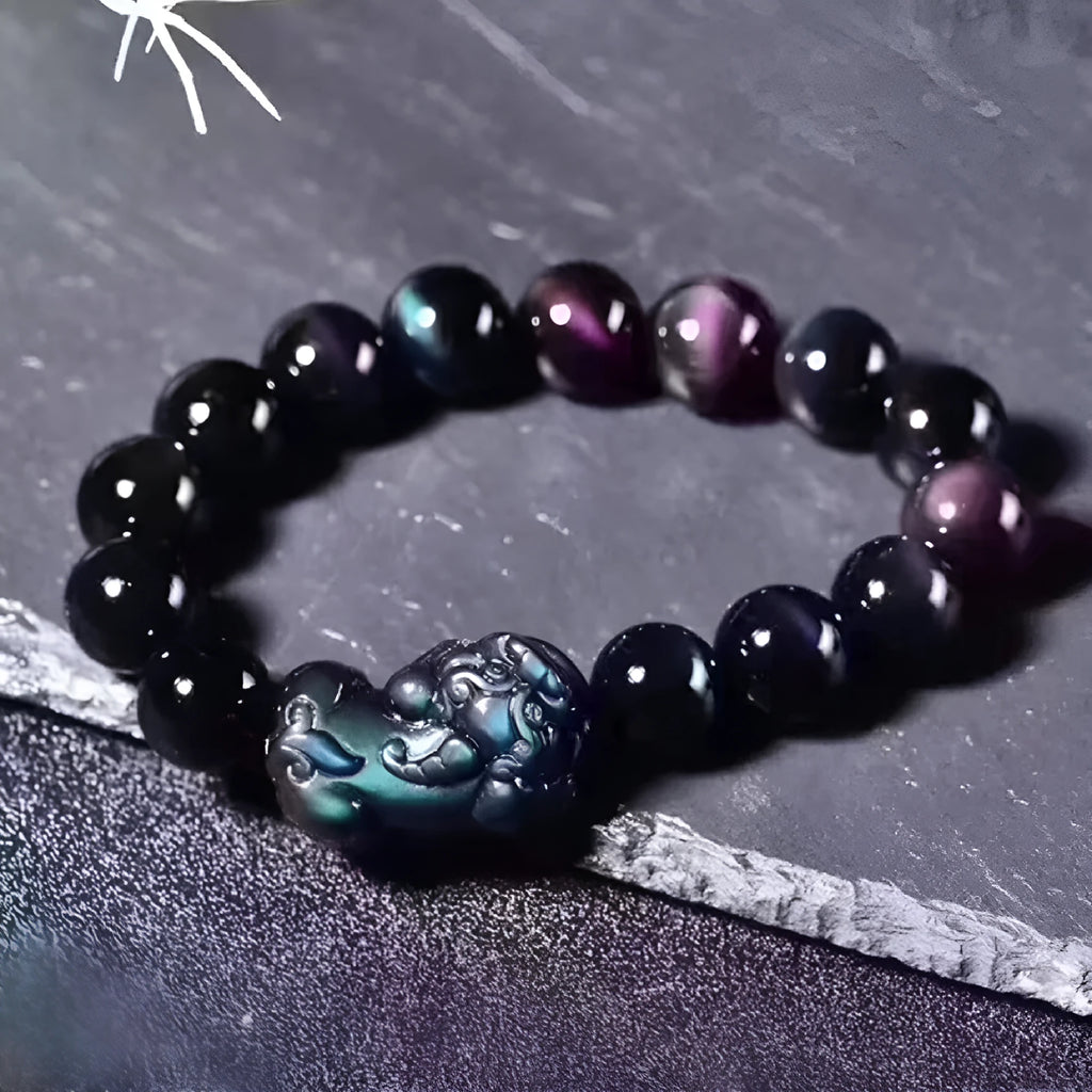 Natural ice colour eye obsidian crystal bracelet with spherical beads on a wrist.