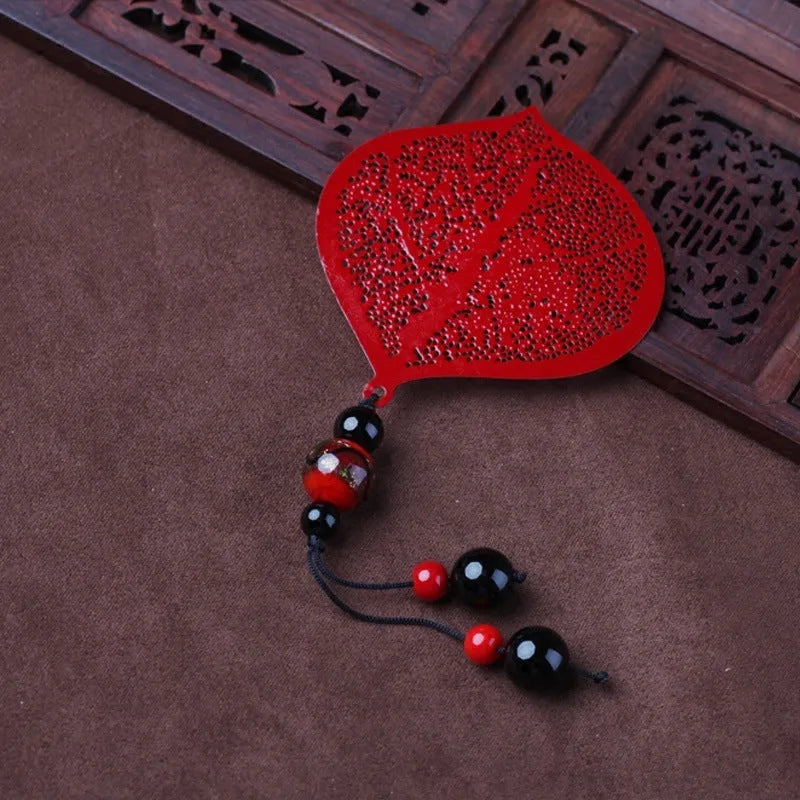 Brass metal bookmark with hollow leaf pattern design and rose gold tassel