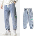 Men's loose-fit tapered cotton trousers in black, blue and grey colours showing mid-waist design