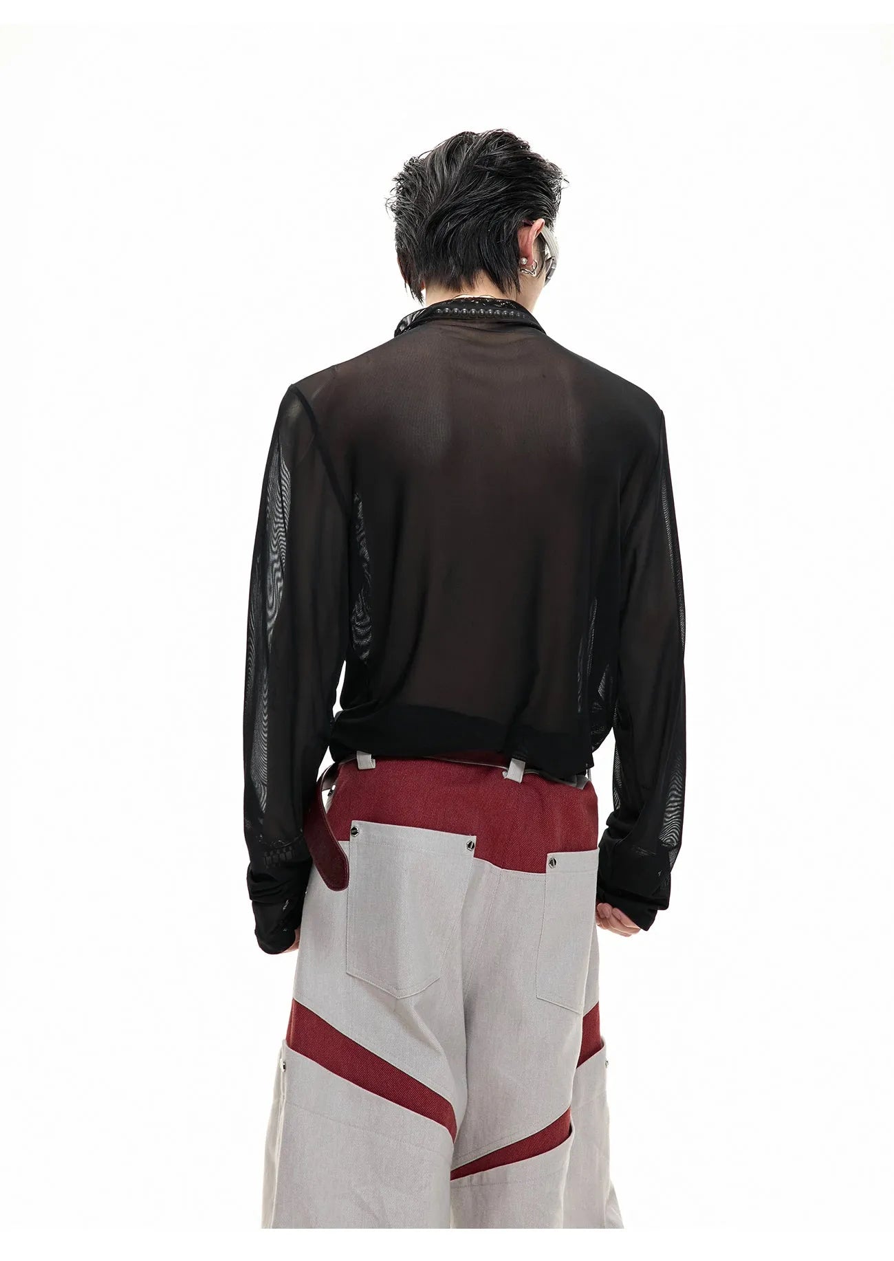 Man wearing a black slim fit long sleeve mesh base layer shirt.