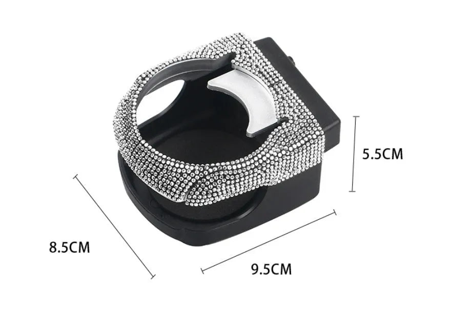 White diamond-encrusted ABS plastic car cup holder bracket mounted on a car air vent.