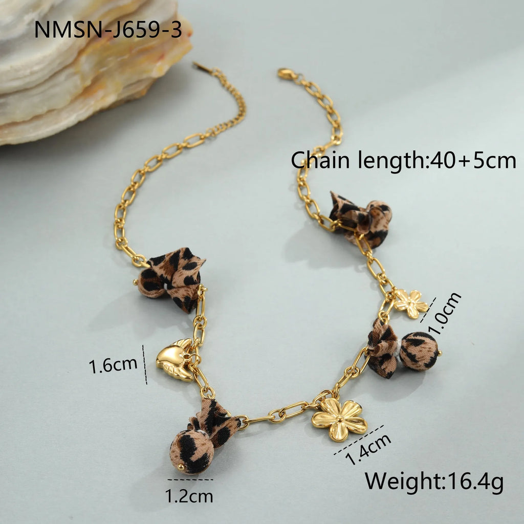 Gold-plated leopard pendant necklace with love heart and flower detailing on adjustable chain