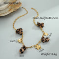 Gold-plated leopard pendant necklace with love heart and flower detailing on adjustable chain