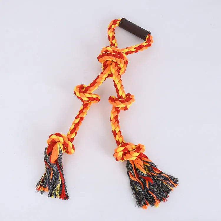 Blue and yellow woven cotton rope dog tug toy with a handle, shown next to a large dog.